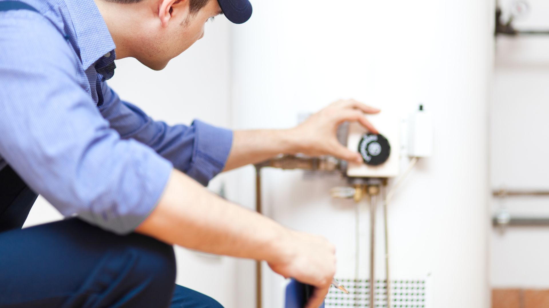 A man is fixing a water heater