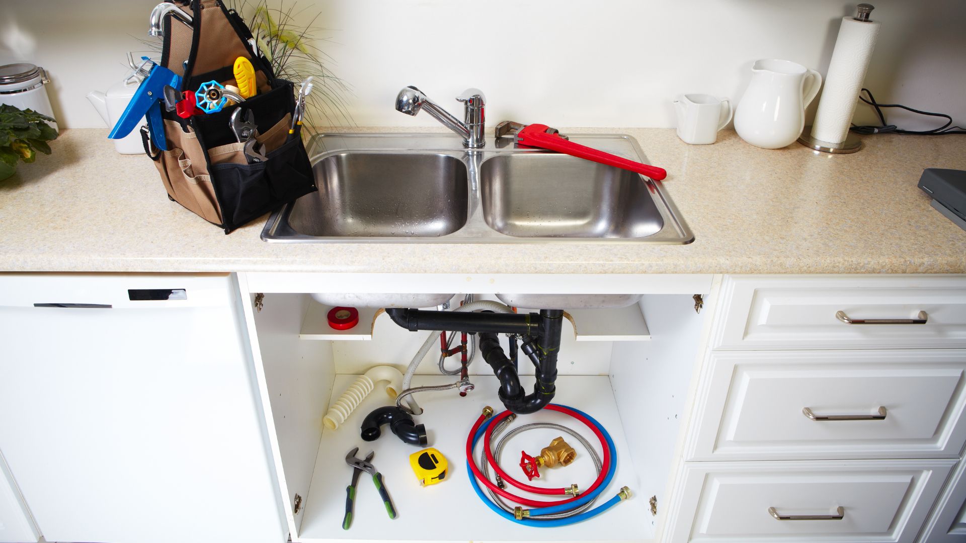 A kitchen sink with a bunch of tools in it