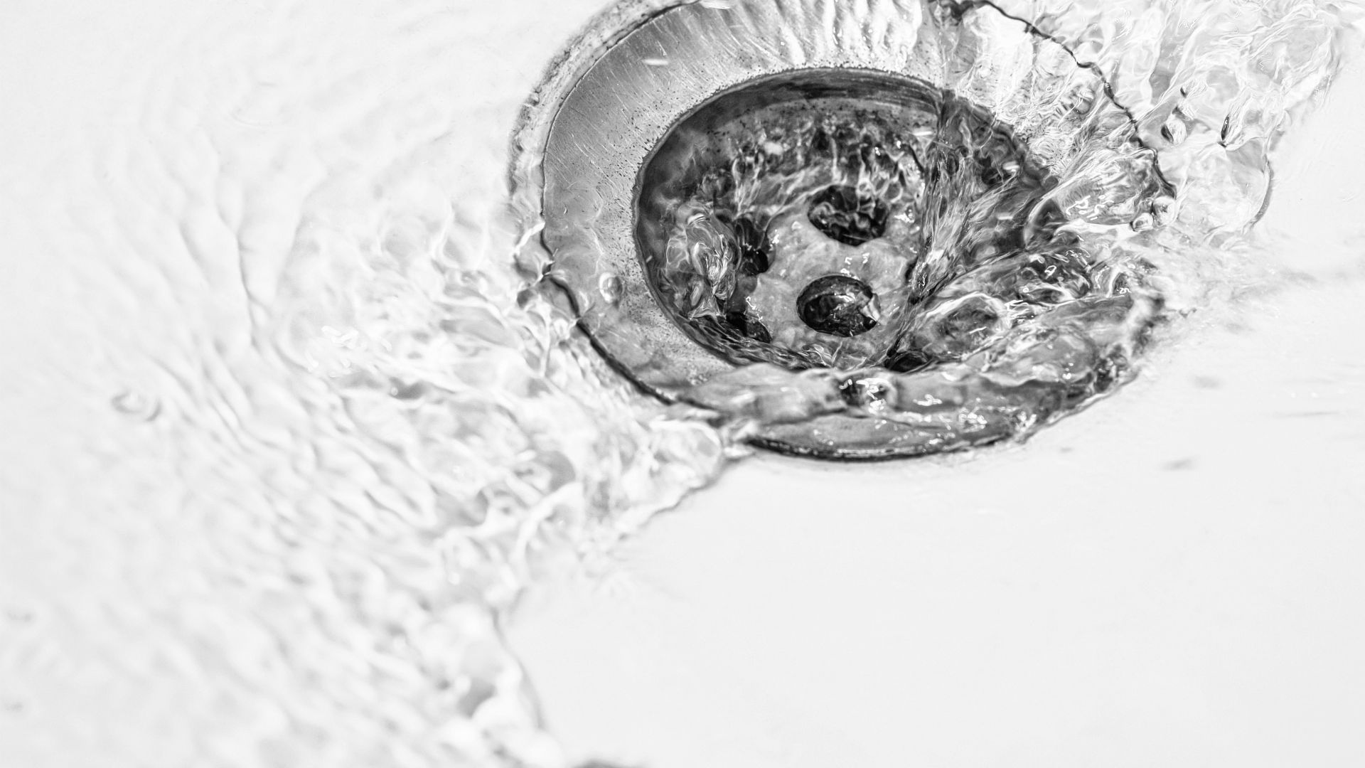 A sink drain with water running down it